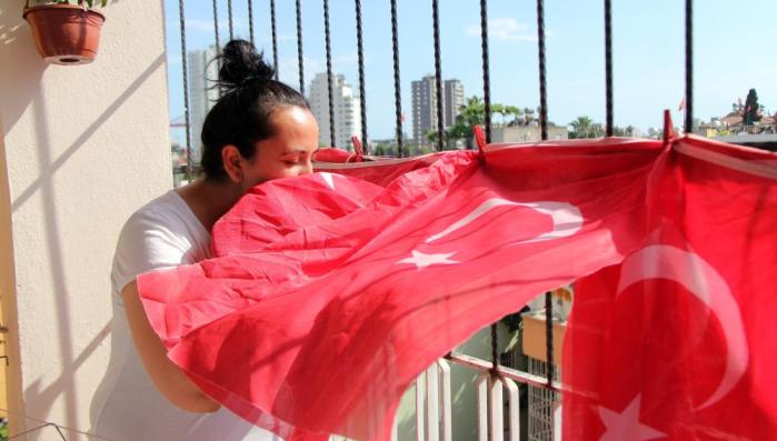 TÜRK BAYRAKLARINI ÇÖPTEN ÇIKARIP BALKONUNA ASTI
